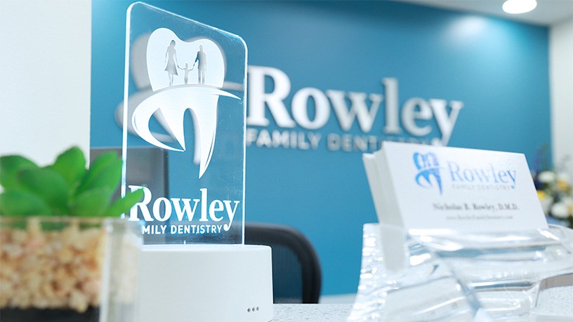 Stack of business cards on front desk at Rowley Family Dentistry
