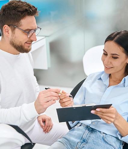 A patient paying for dental implant treatment