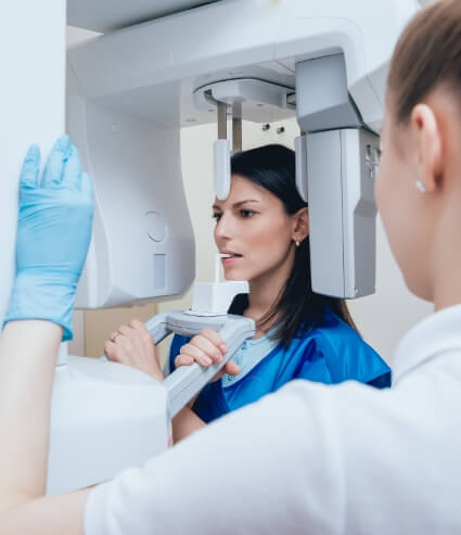 Woman receiving 3 D cone beam dental scan of her mouth and jaw