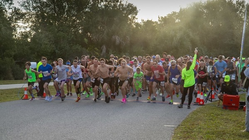 Group of people taking off running at the start of a race