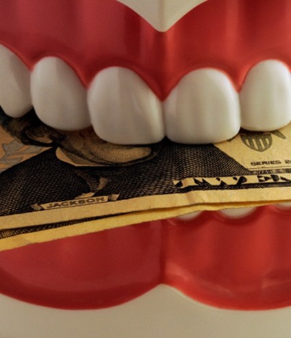 A jaw mockup biting twenty-dollar bills