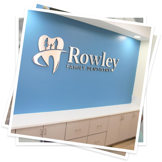 Blue sign on wall reading Rowley Family Dentistry