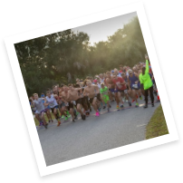 Group of people taking off running at the start of a race