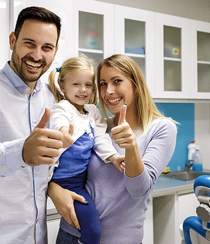 Parents and child in dental office