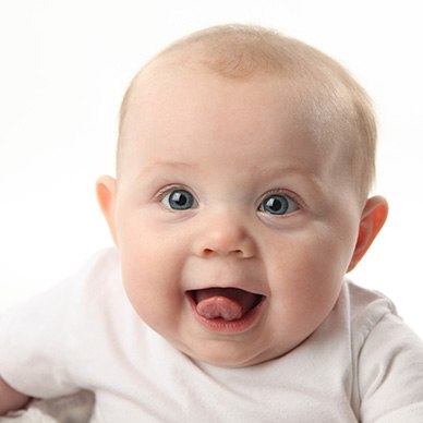 Happy infant sticking their tongue out