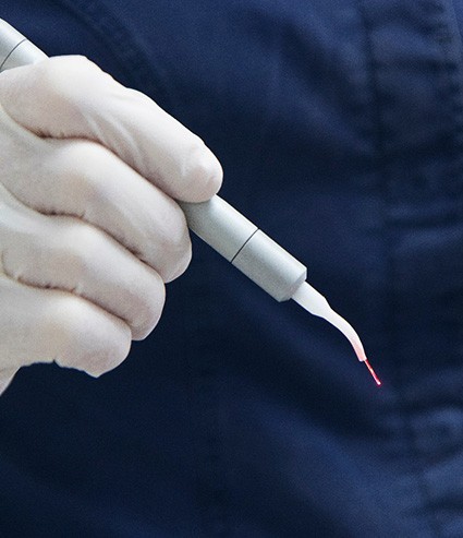 Dental team member holding laser handpiece