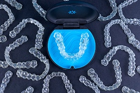 Bird’s eye view of many Invisalign trays with a case in the center