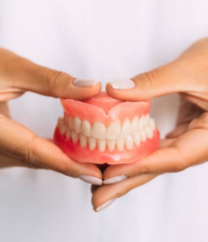 Dentist holding a set of full dentures