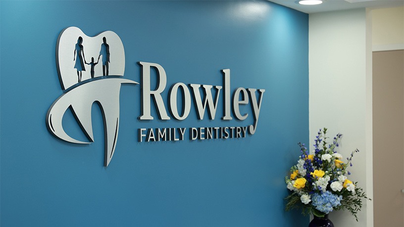 Rowley Family Dentistry sign on blue wall of Melbourne Florida dental office