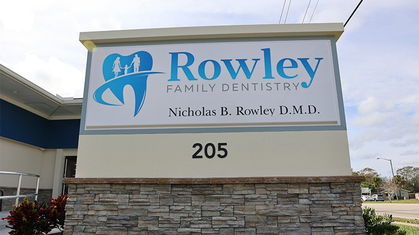 Outdoor sign reading Rowley Family Dentistry Nicholas B Rowley D M D