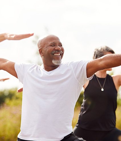 Man smiling during workout class outside