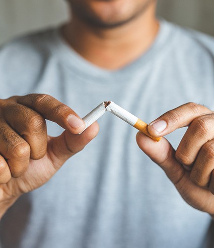 Closeup of patient breaking cigarette