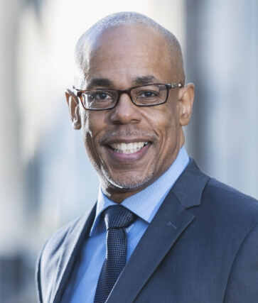 Older man in suit smiling