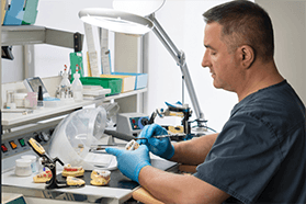 Dental technician in Melbourne working on dentures
