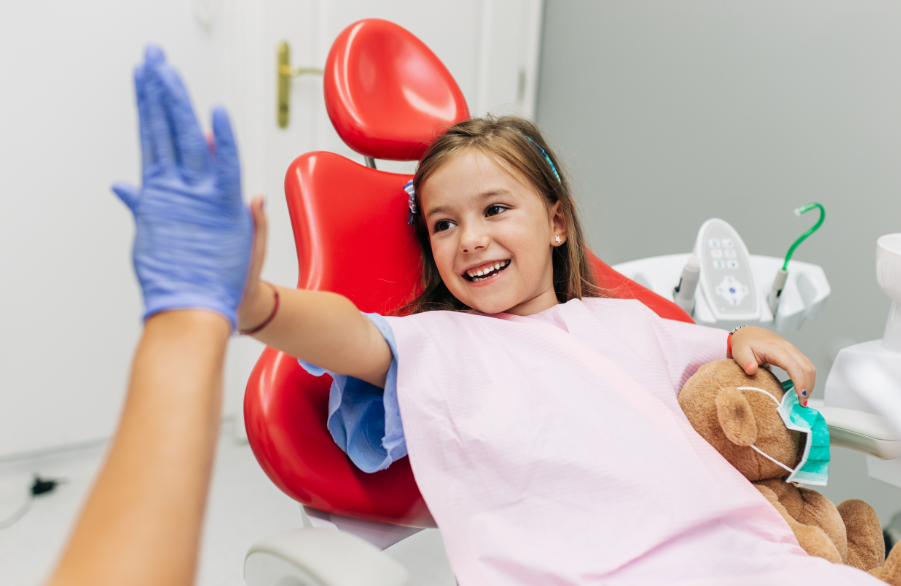Child high fiving dentist
