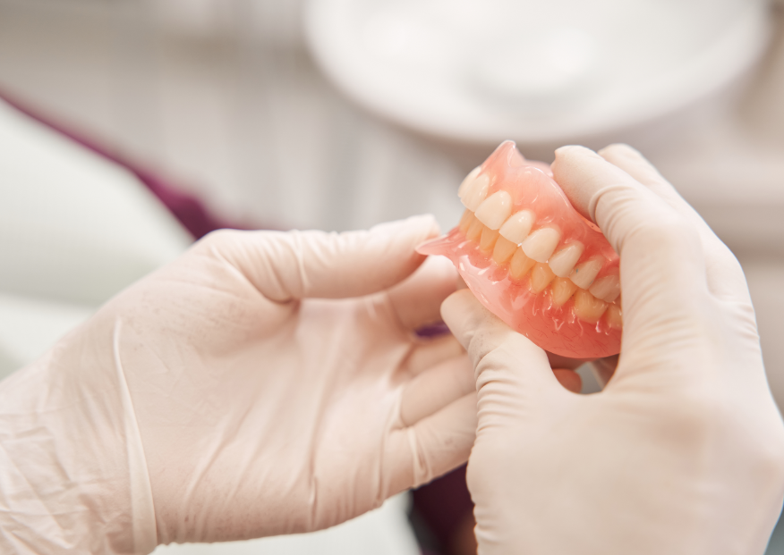 Dentist holding dentures